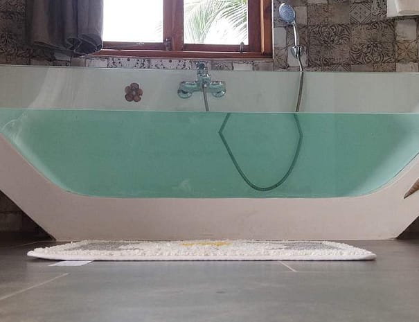 Luxury bathroom with glass bathtub and toilet